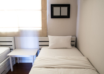 White blanket and pillow on bed in bedroom