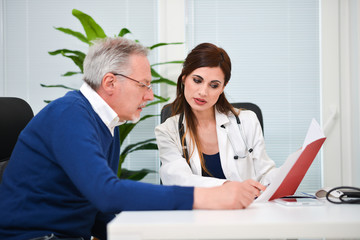 Fototapeta premium Doctor speaking to her patient while showing some documents