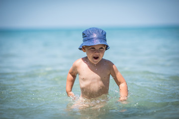 Little boy playing in water on holiday