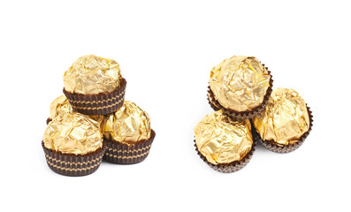 Pile of golden confection candies isolated