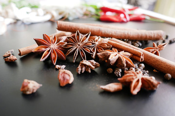 Herbs, condiments on black background