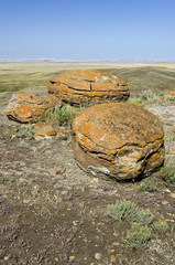 Three spherical sandstone concretions at Red Rock Coulee Provincial Park, near Medicine Hat, in southern Alberta, Canada