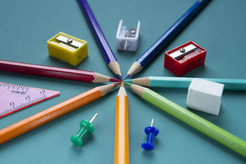 Stationery on a green background, eraser, buttons, ruler,  sharpener  