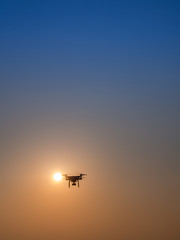 Fototapeta na wymiar Drone Flying in The Sky Behind The Sun