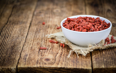 Goji Berries (selective focus) on vintage wooden background