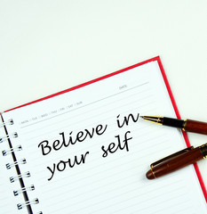 Communication message motivation concept with " Believe in your self " word on notebook.