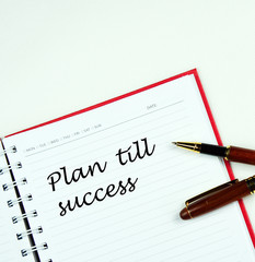 Communication message motivation concept with "Plan till success" word on notebook.