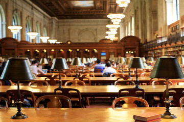 Fototapeta premium Books on the table in the reading room in the library