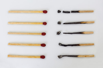 Burnt matchsticks and new matchsticks on white background. Different stages of matchsticks.