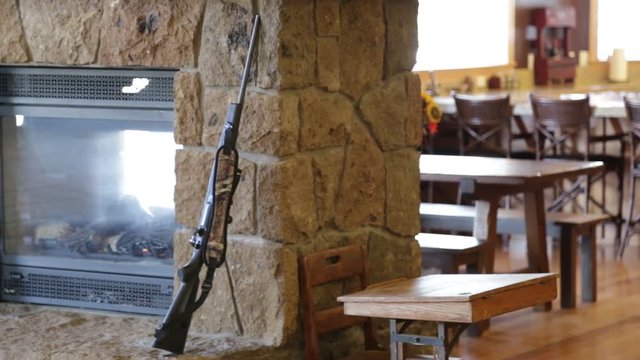 Fireplace in stone hearth with leaning gun