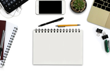 White office desk with smartphone with black screen, pen, laptop computer, notepad with copy space, and supplies. Top view with copy space