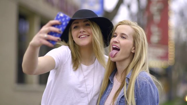 Cute Teens Take Fun Selfies Together On City Adventure