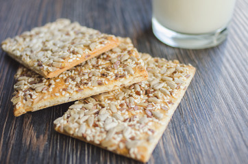 cookies with cereals and milk: sesame, seeds. On a wooden background.Top view. Cooking concept. Concept of healthy food.