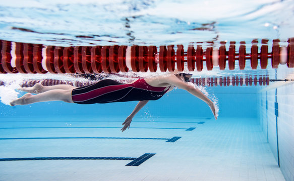 Woman swimming pool.Underwater photo