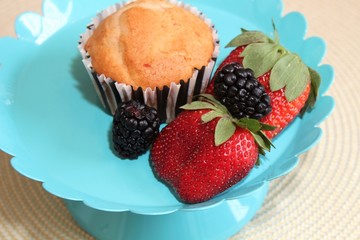 Fresh baked muffins with blueberries and strawberries
