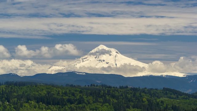 Time lapse video of moving white clouds and blue sky over beautiful snow covered Mt. Hood from Jonsrud Viewpoint in Sandy Oregon 4k UHD