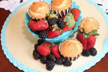 Fresh baked muffins with blueberries and strawberries