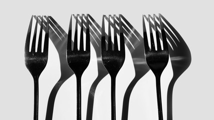 Fork and spoon in black and white / spoons are the primary utensil used for eating and forks are...