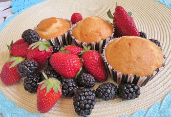 Fresh baked muffins with blueberries and strawberries