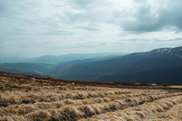 Landscape of great snowy peak of the mountains in spring in the cloudy day