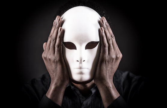 Dramatic art portrait of african black man with white mask.