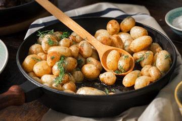Fried young potatoes in a cast-iron frying pan