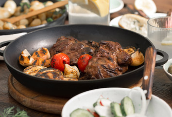 Beef steak grilled in grill pan on wooden table