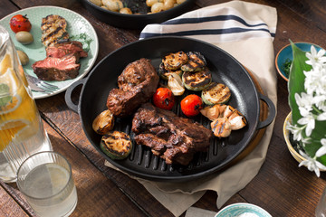 Beef steak grilled in grill pan with grilled vegetables