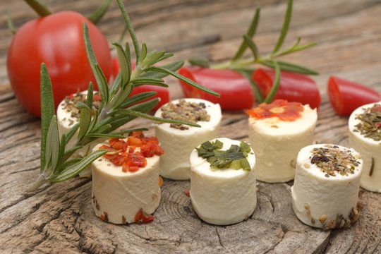 Greek feta cheese pieces on wooden background