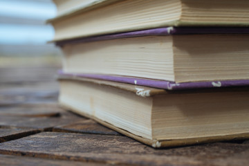 Stack old books on wooden background