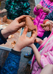 Obraz na płótnie Canvas Hands teachers show children modeling clay