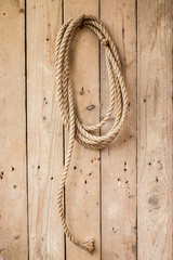 Brown string hanging on wooden wall