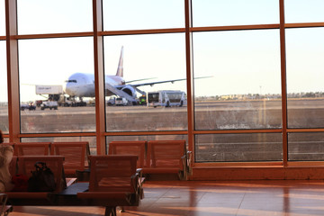 waiting hall airport window sun plane