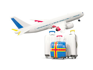 Luggage with flag of aland islands. Three bags with airplane