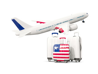Luggage with flag of liberia. Three bags with airplane