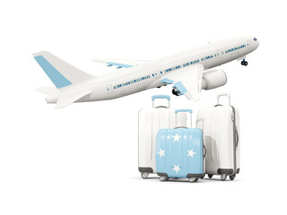 Luggage with flag of micronesia. Three bags with airplane