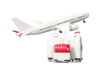 Luggage with flag of monaco. Three bags with airplane