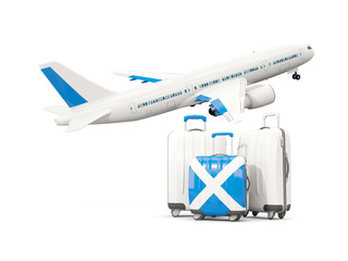 Luggage with flag of scotland. Three bags with airplane
