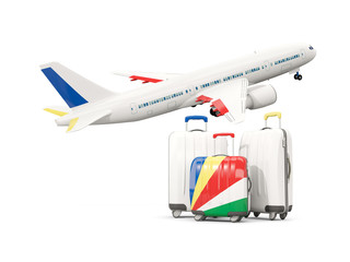 Luggage with flag of seychelles. Three bags with airplane