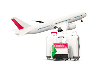 Luggage with flag of sudan. Three bags with airplane
