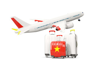 Luggage with flag of vietnam. Three bags with airplane