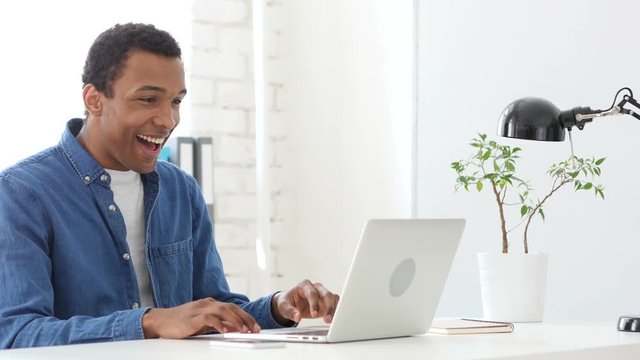 Happy Afro-American Man Working On Laptop in Office