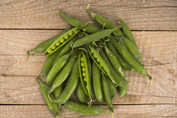 Green peas on a wooden background