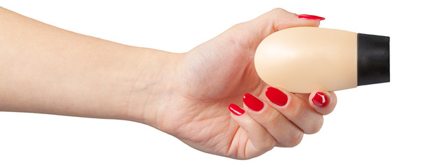 plastic tube for cosmetics in female hand.