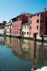 Fototapeta na wymiar Reflections along the canals of Chioggia, Venice and its lagoon.