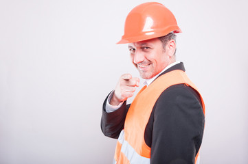 Side view of engineer wearing reflective vest pointing camera