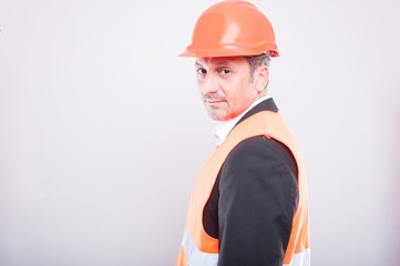 Side view of engineer wearing hardhat and reflective vest