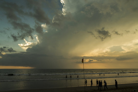 Beautiful sunset of Kuta Beach, Bali, Indonesia. Silhouettes of people at sunset on Kuta beach in Bali, Indonesia