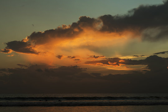 Beautiful sunset of Kuta Beach, Bali, Indonesia. Silhouettes of people at sunset on Kuta beach in Bali, Indonesia