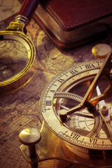 Old compass over ancient map